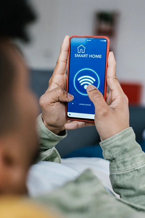 Homeowner using a smartphone connected to a residential home network Homeowner using a smartphone connected to a residential home network