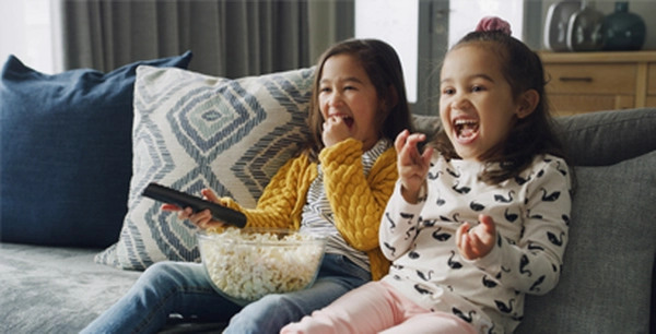 Simple home audio and video systems Young girls watching TV in an easy to use home video system