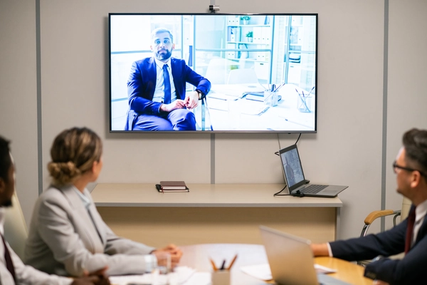 Small biz meeting room with video conferencing system Small business meeting room with commercial video conferencing system
