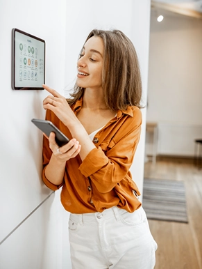 Woman using a Smart Home automation control panel in Tucson Woman using a Smart Home automation control panel in Tucson