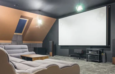 how-to-plan-a-home-theater Home theater setup with screen, surround speakers and theater seating