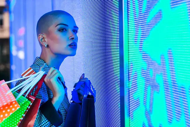 stylish woman at shopping retail with a video wall Woman at retail store near a video wall screen